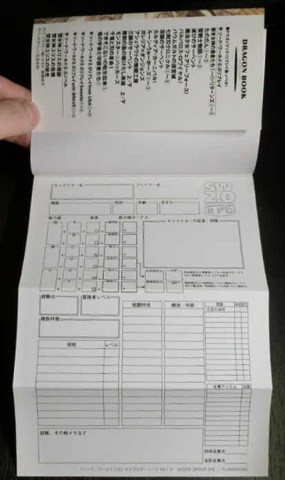 The character sheet folds out from the front of the book.