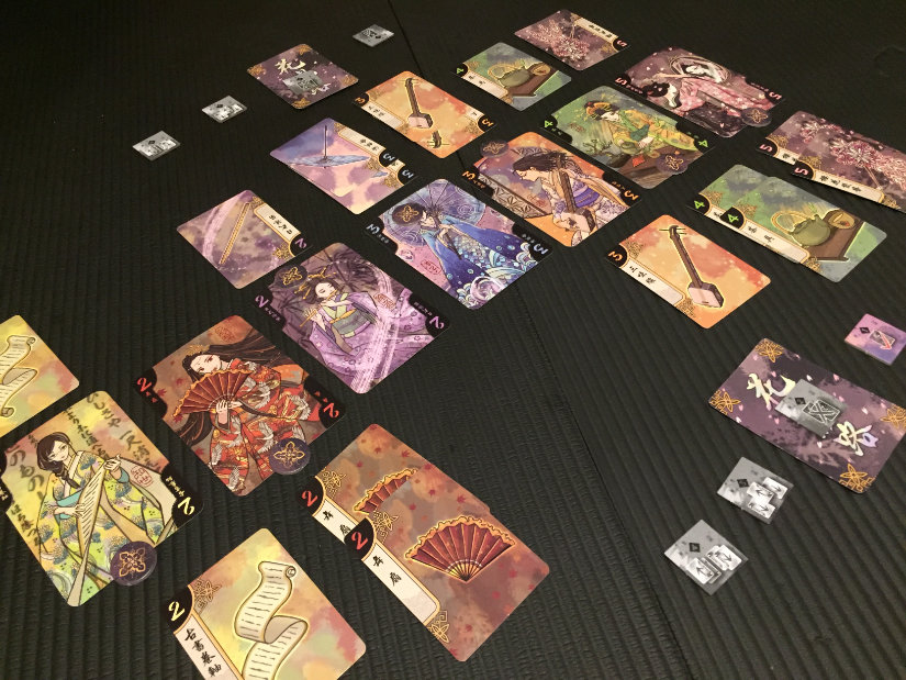 Scoring - the victory token is moved towards the winner of each geisha. The grey tokens are the used-side of the action tokens. The cards under them were discarded as part of action two.