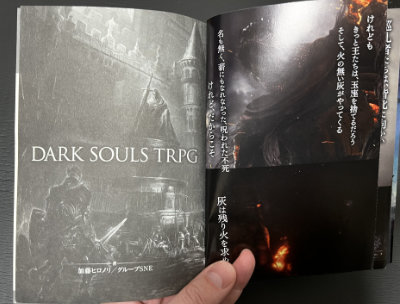 Dark Souls TRPG book opened to the end of the prologue and opening art of the book.