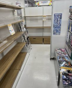 View of a store isle, the majority of which is empty. Some TRPG books are visible on the right.
