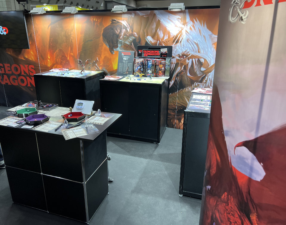 D&D booth showcasing products and game tables.