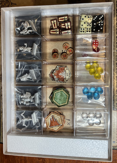 Box contents: metal miniatures, tokens, dice, and counters