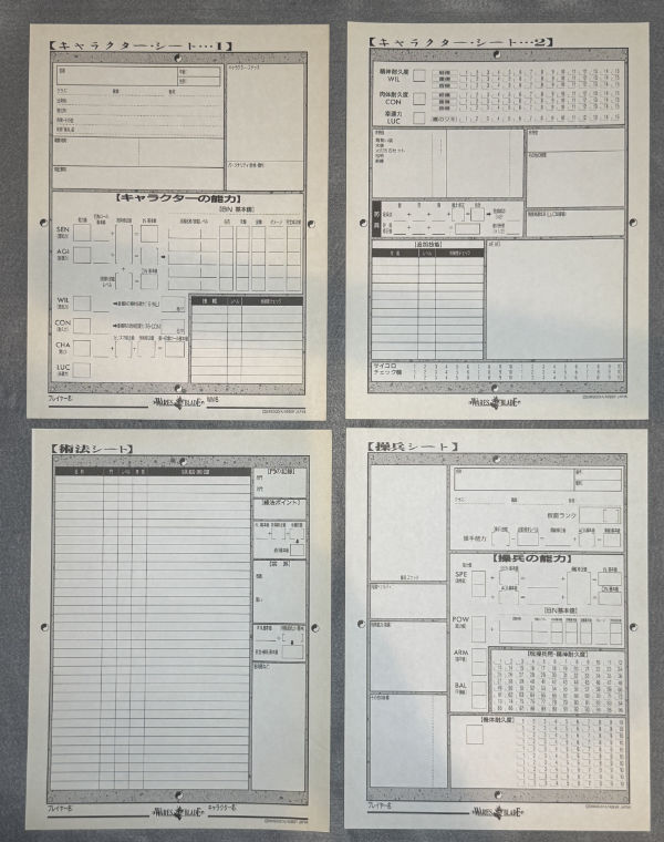 The four character sheets spread out flat.
