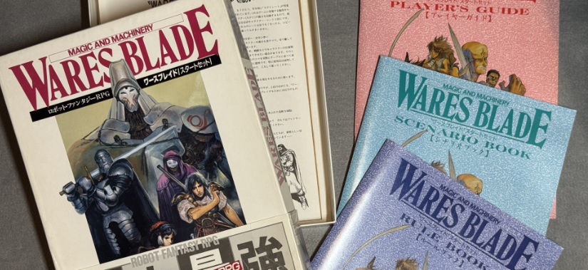 An opened Wares Blade - Magic & Machinery box with the three booklets next to it.