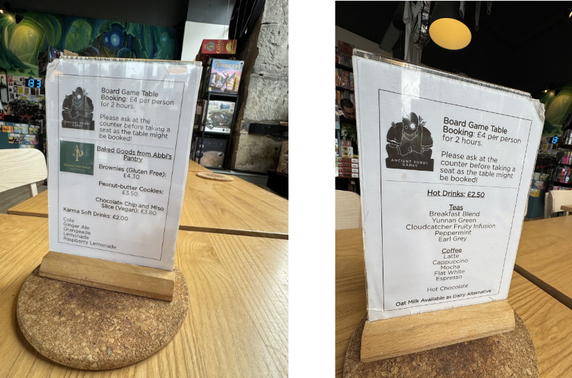 Placards on the table listing rental fees, pastries, and hot drinks.