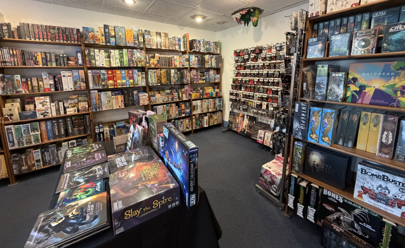 Board games and miniatures on tables and shelves