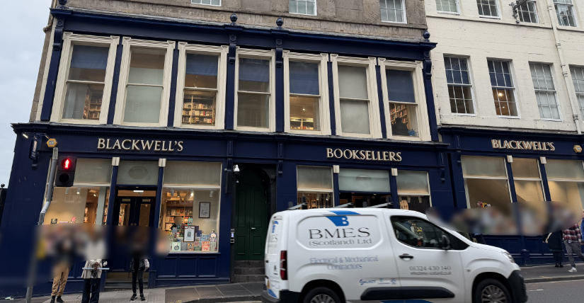 The front of Blackwell's with large windows and black painted walls.