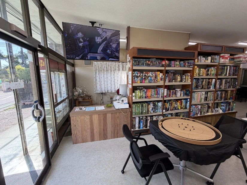 Entry way with register, games, and interesting disk flicking game on a table.