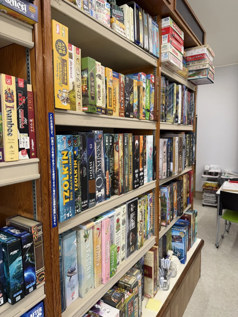 Board games lining a shelf.